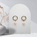 Handmade 316L gold-plated stainless steel 16 mm huggie hoop earrings with removable 7 mm soft pink freshwater pearls and white rice pearl charms.