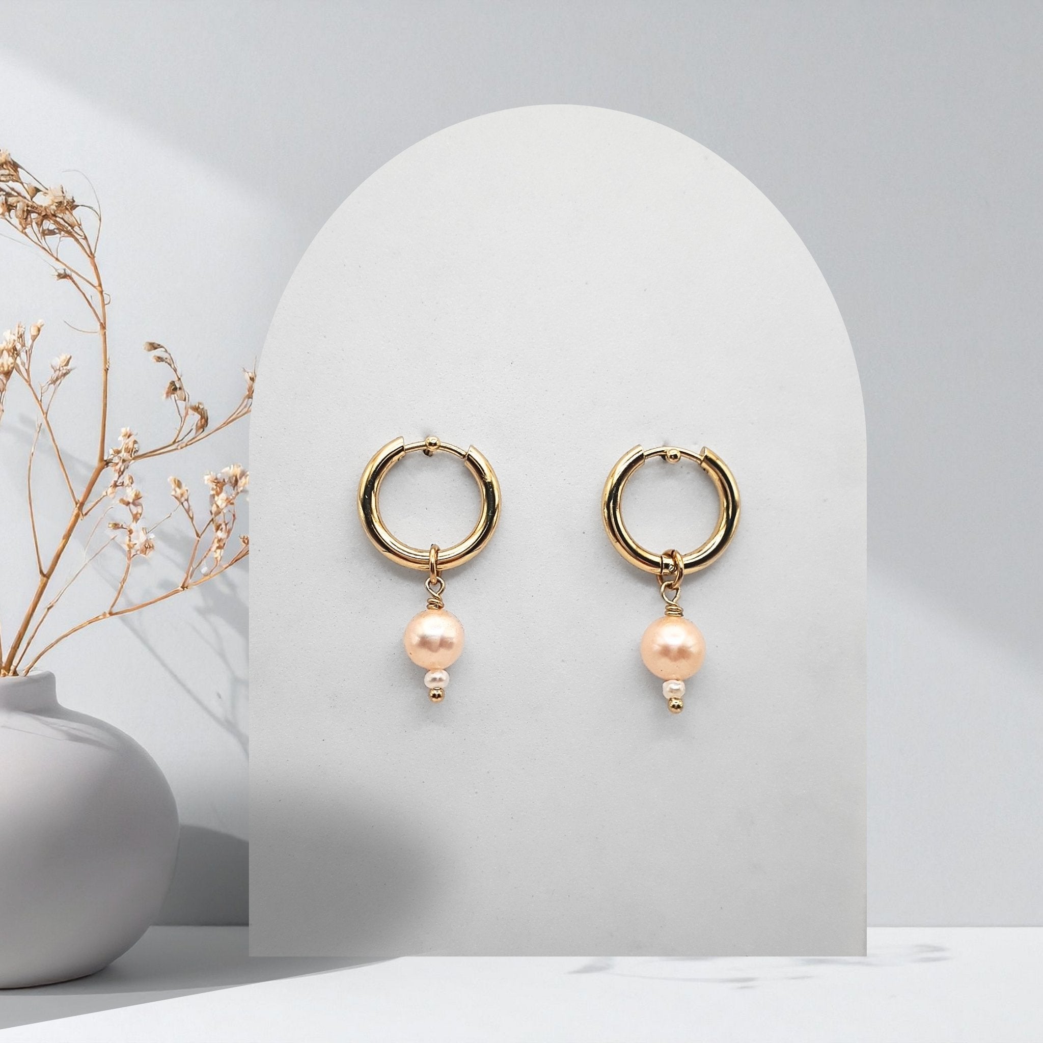 Handmade 316L gold-plated stainless steel 16 mm huggie hoop earrings with removable 7 mm soft pink freshwater pearls and white rice pearl charms.