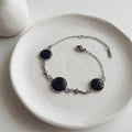 Handmade 304 stainless steel bracelet with natural crushed Starstone in one 12mm and two 10mm bezel settings, stainless steel cross connectors and lobster clasp.