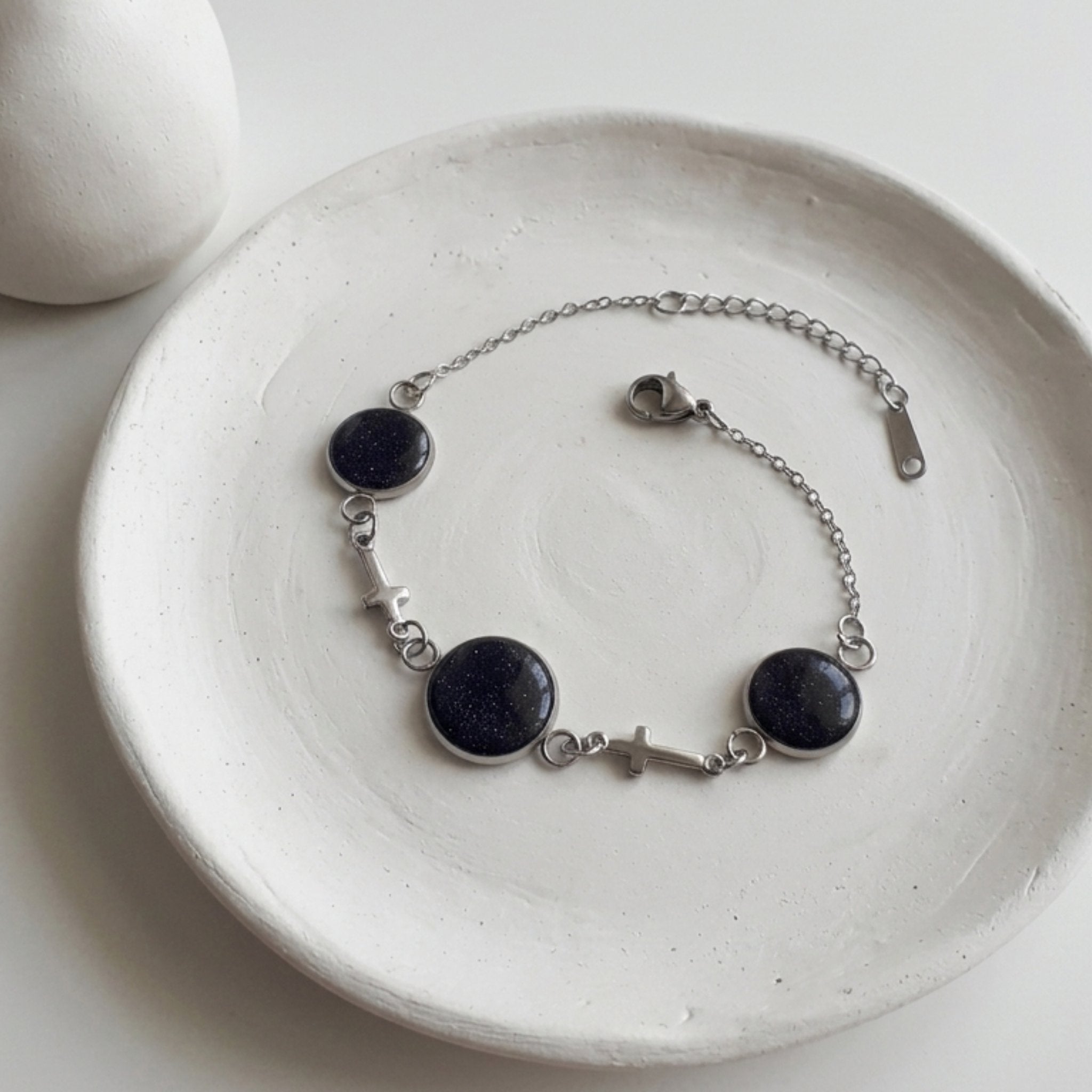 Handmade 304 stainless steel bracelet with natural crushed Starstone in one 12mm and two 10mm bezel settings, stainless steel cross connectors and lobster clasp.