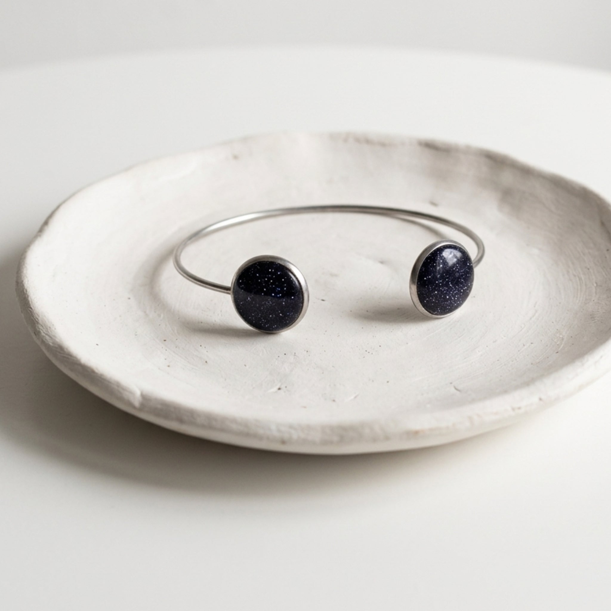 Handmade 304 stainless steel cuff bangle with natural crushed Star Stone 12mm bezel settings and clear resin finish.