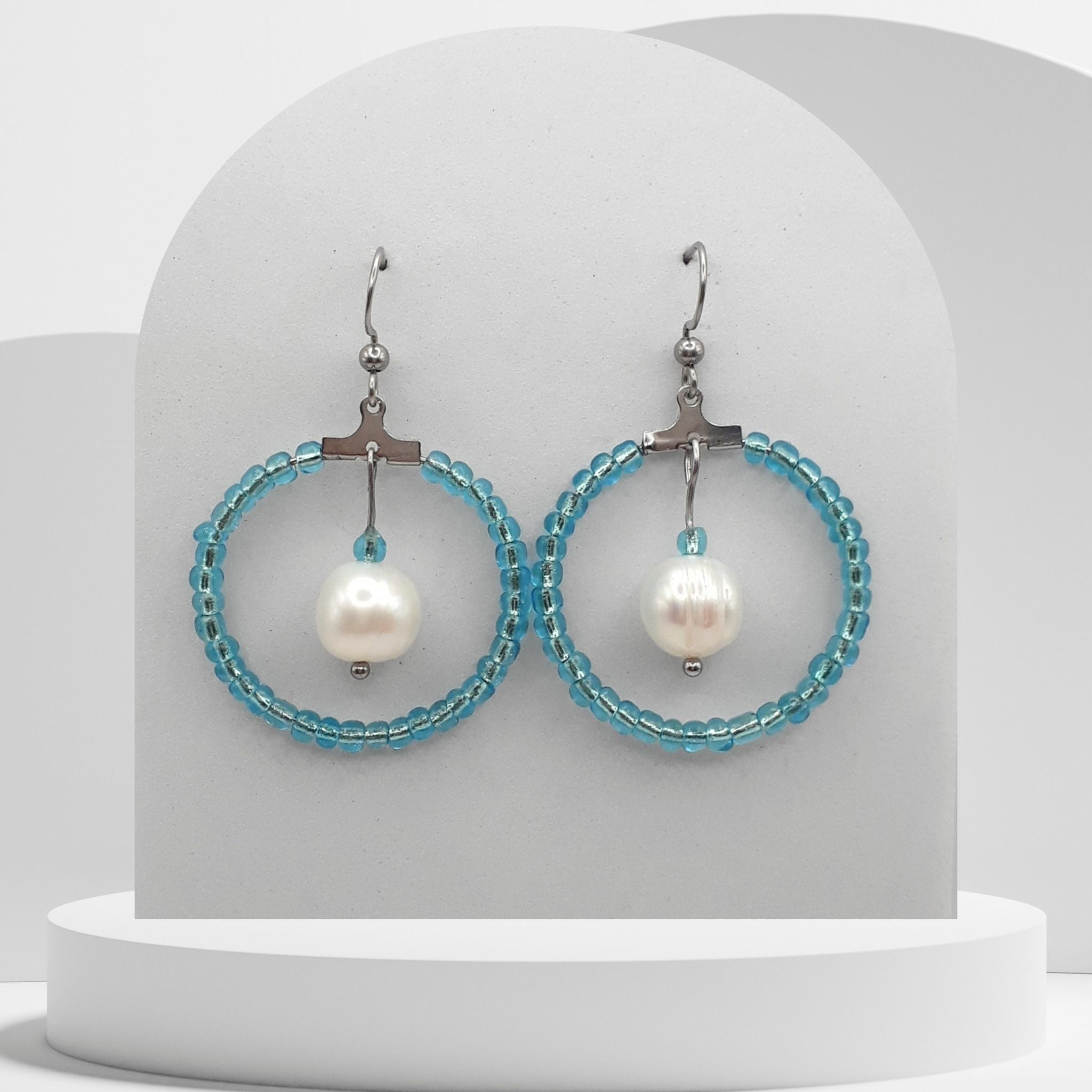 White pearl drop earrings with turquoise beaded stainless steel hoop