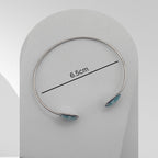 Handmade stainless steel open cuff bangle with natural turquoise sealed in resin