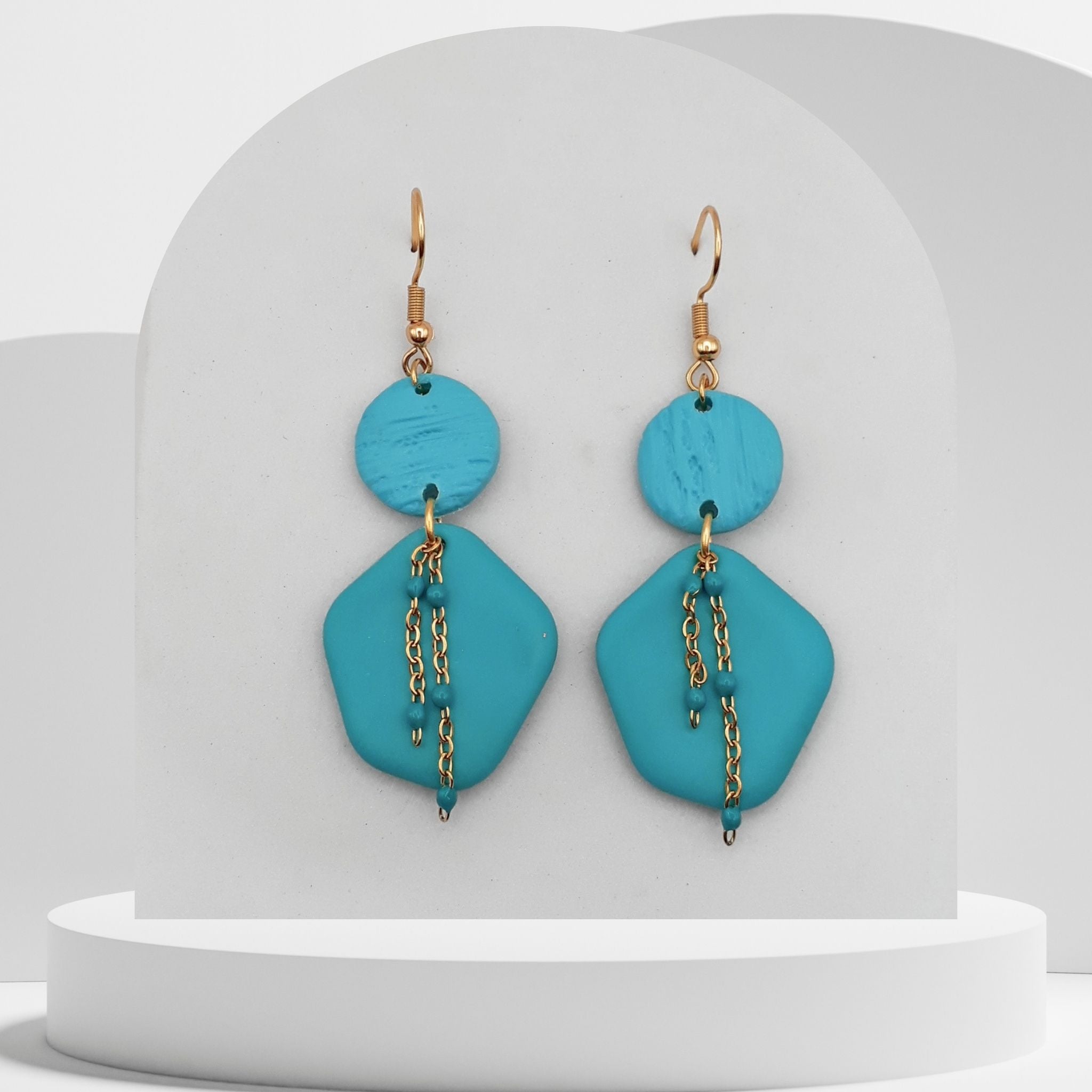 Turquoise polymer clay geometric drop earrings with gold chain detail and gold hooks