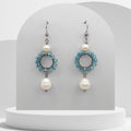 Handmade stainless steel dangle earrings with turquoise glass beaded circle and two natural white freshwater pearls