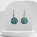 Stainless steel drop earrings with 18mm bezel set crushed turquoise gemstones sealed in glass-like resin on shepherd hooks