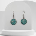 Stainless steel drop earrings with 16mm bezel set crushed turquoise gemstones sealed in glass-like resin on shepherd hooks