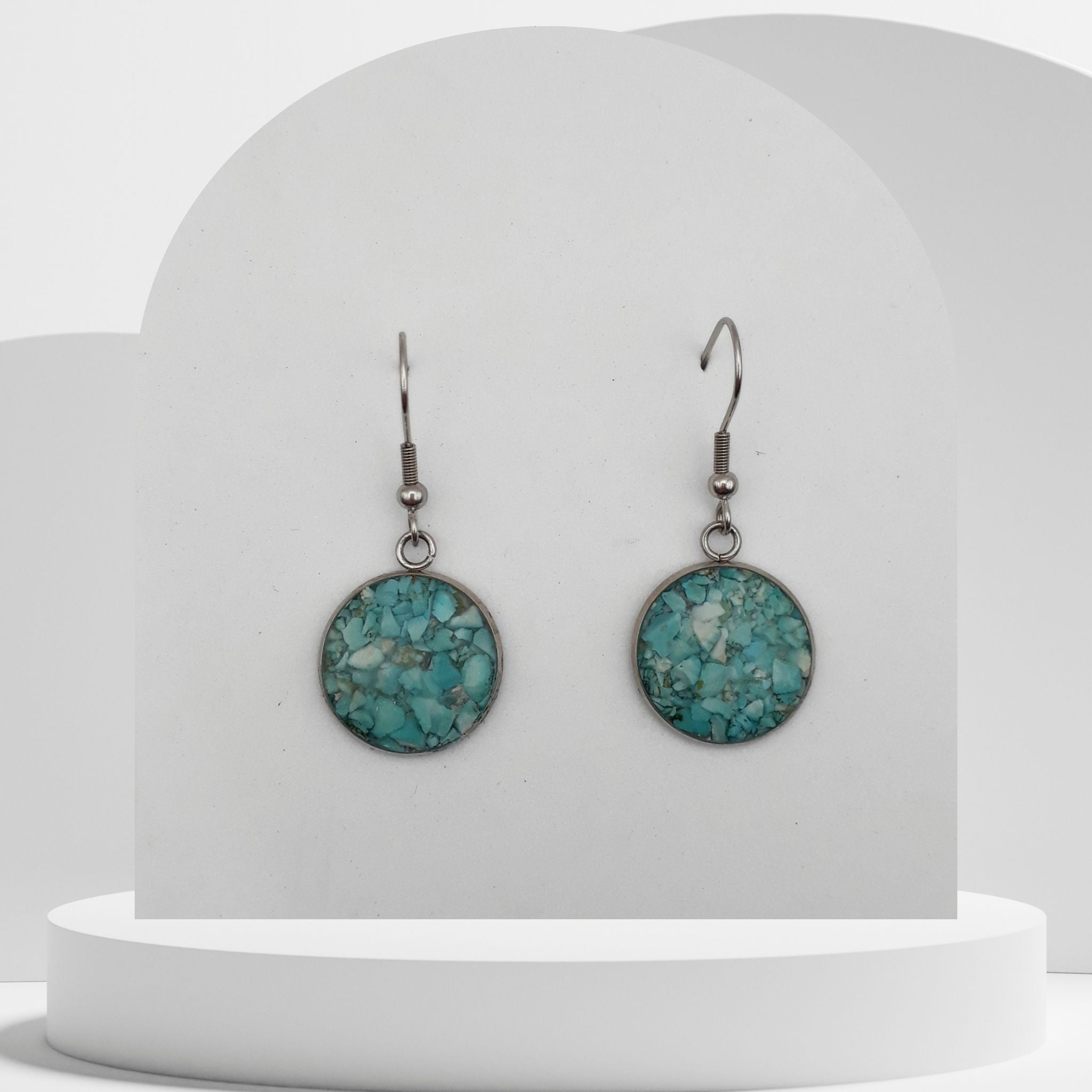 Stainless steel drop earrings with 16mm bezel set crushed turquoise gemstones sealed in glass-like resin on shepherd hooks