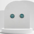 Stainless steel stud earrings with 12mm bezel set crushed turquoise gemstones sealed in glass-like resin