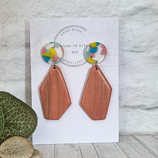 Make a creative statement with these quirky marble effect pink polymer clay earrings! Handmade and featuring Perspex round ear studs with stainless steel pins