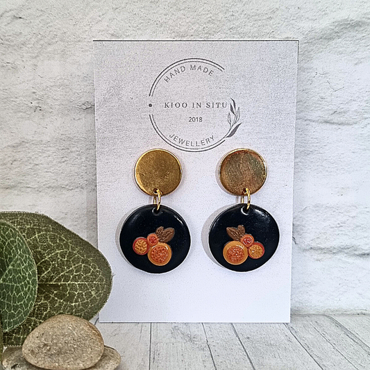 Sculpt new fashion looks with these handmade polymer clay earrings! Featuring dark blue and orange little fruits