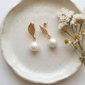 White 10mm freshwater pearl drop earrings with gold-plated 304 stainless steel leaf-shaped studs