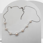 Handmade stainless steel necklace with white freshwater pearls and center pearl design