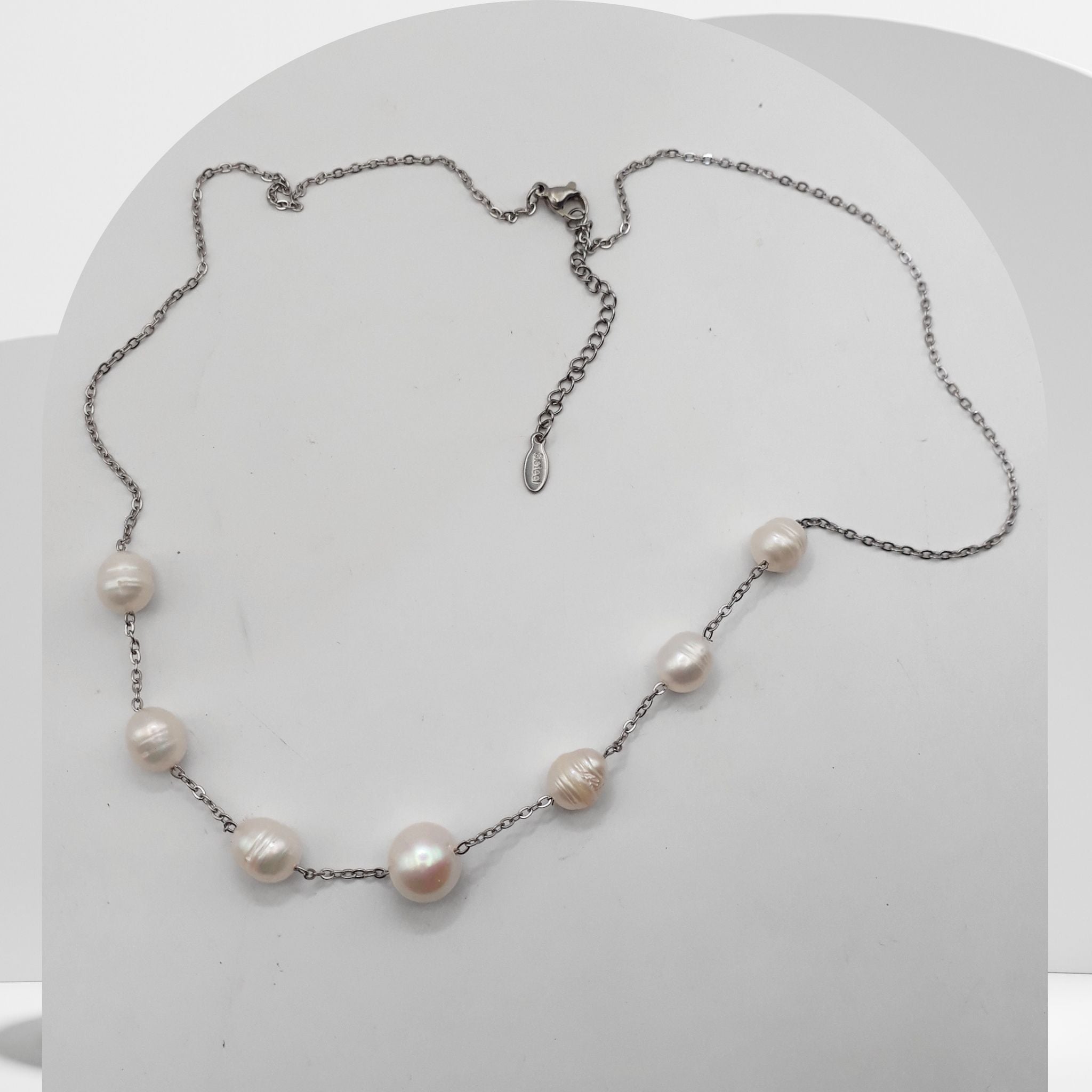 Handmade stainless steel necklace with white freshwater pearls and center pearl design