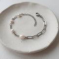 Handmade white freshwater pearl bracelet with four natural pearls and stainless steel paperclip and cable chains.