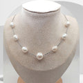 Handmade stainless steel necklace with white freshwater pearls and center pearl design