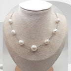 Handmade stainless steel necklace with white freshwater pearls and center pearl design