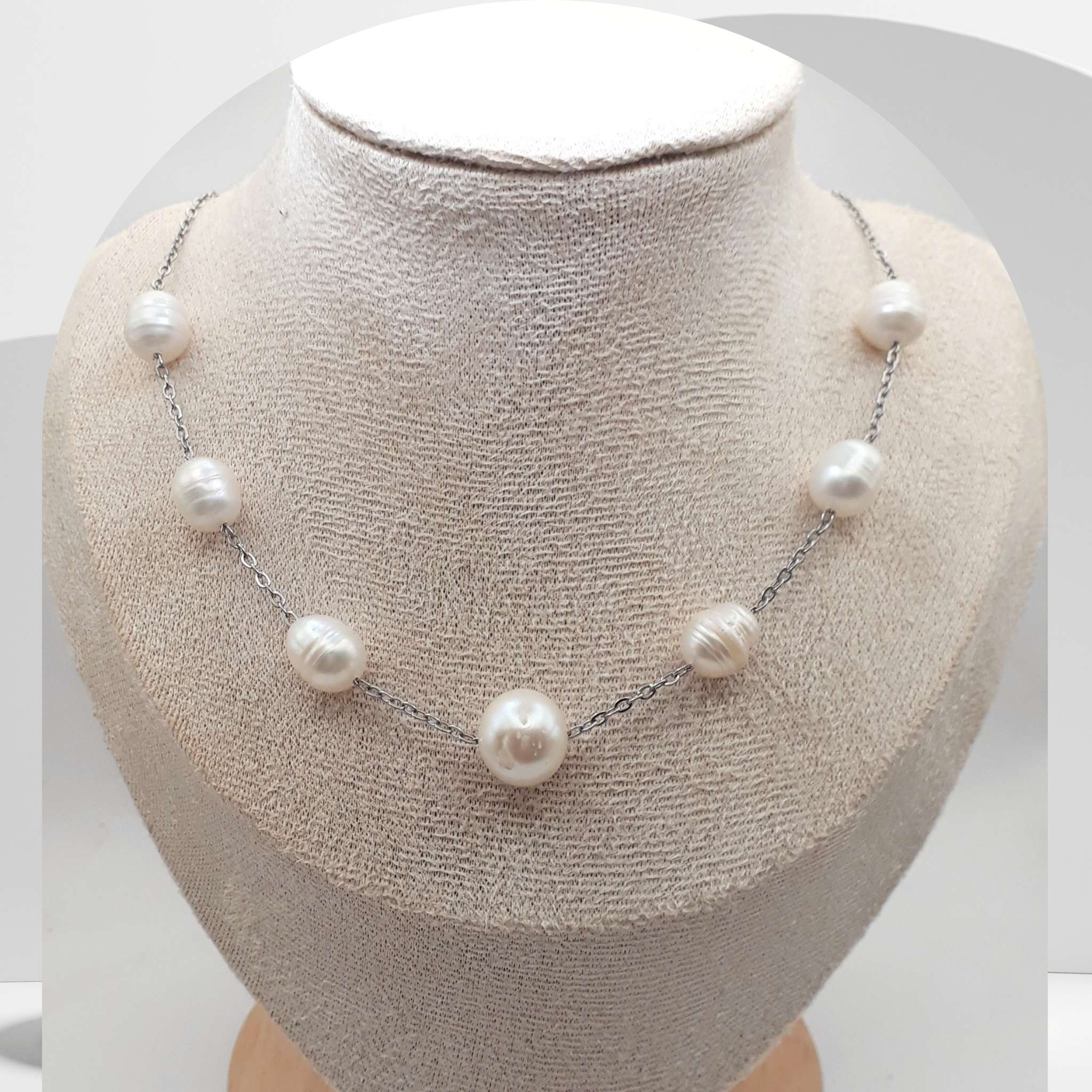 Handmade stainless steel necklace with white freshwater pearls and center pearl design