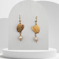 Handmade white freshwater pearl drop earrings with gold monstera leaf design
