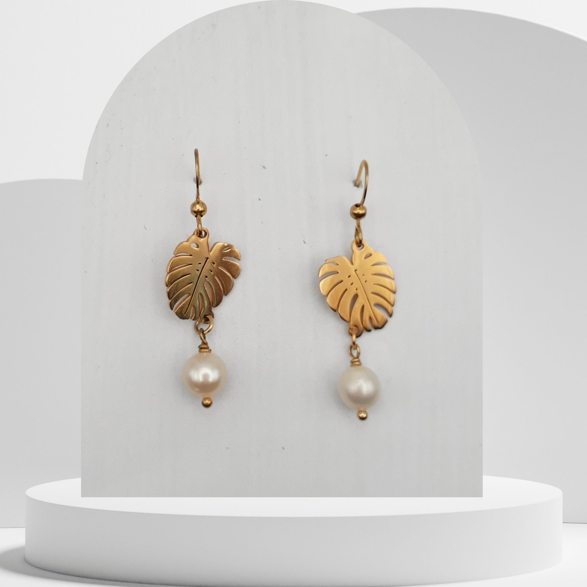 Handmade white freshwater pearl drop earrings with gold monstera leaf design