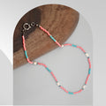 Handmade white freshwater pearl necklace with pastel pink and blue glass beads