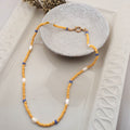 Handmade yellow glass bead necklace with seven natural white rice pearls and blue ceramic beads