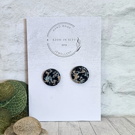 Explore your style with these handmade Polymer Clay Ear Studs. Each 14 mm stud offers lightweight comfort and is available in a charming Black, silver and tan hue.