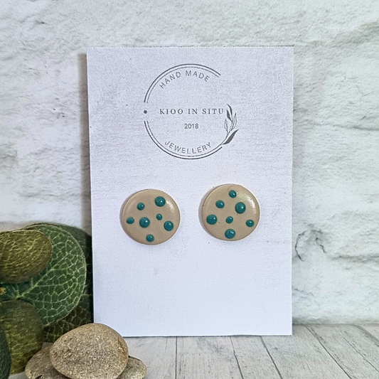 Explore your style with these handmade Polymer Clay Ear Studs. Each 16 mm stud offers lightweight comfort and is available in a charming cream color with turquoise dots.